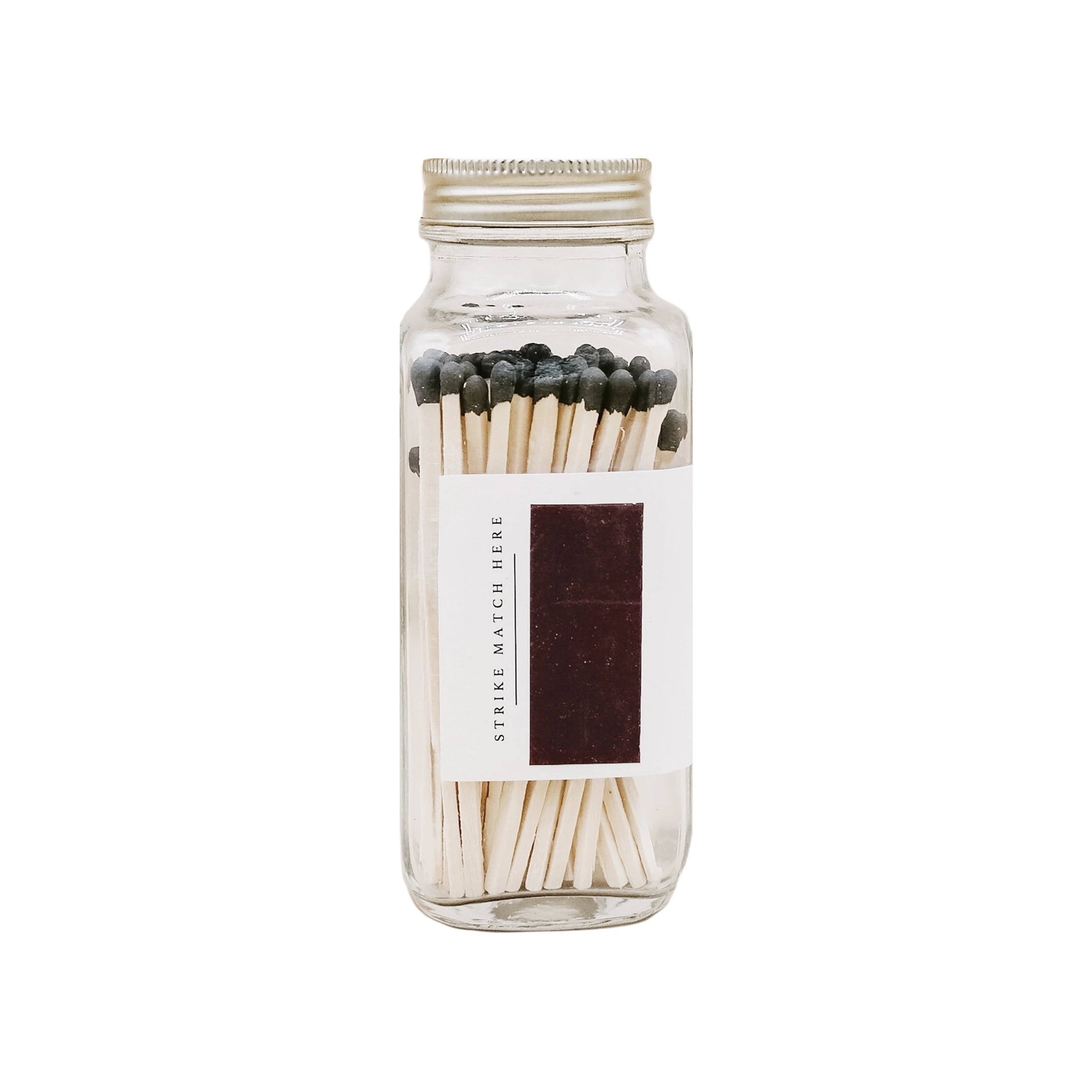 Clear glass jar with matches on a white background