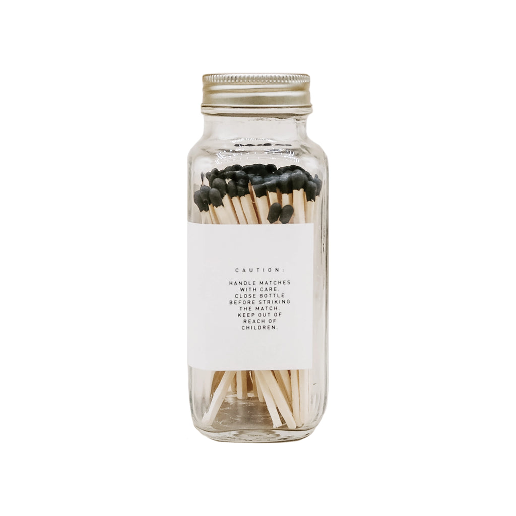 Glass jar with matches on a white background