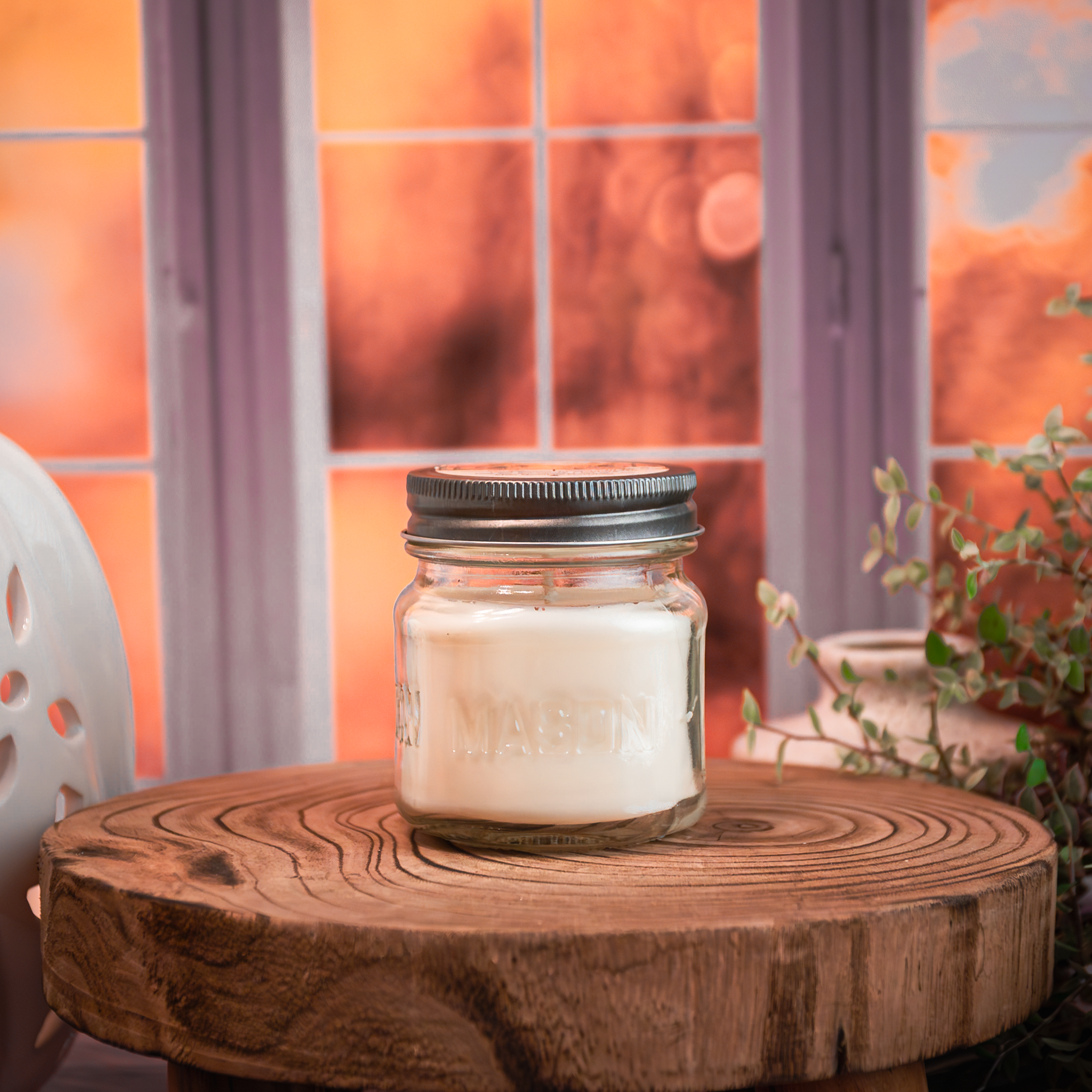 Autumn candle in glass jar surrounded by fall leaves – Fallen Leaves fragrance