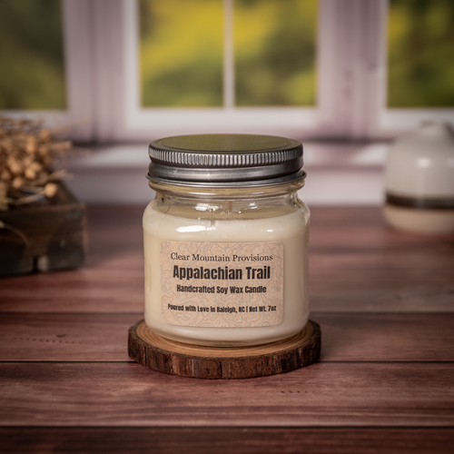 Appalachian Trail soy wax candle with moss, leather, and smoky cedar scent in eco-friendly medium mason jar.