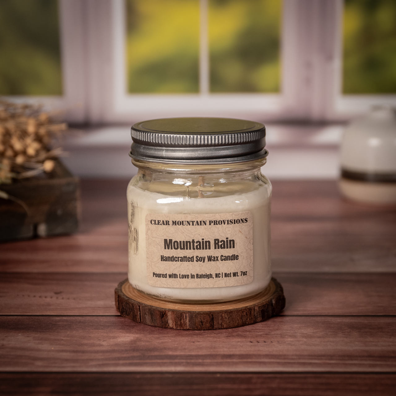 Mountain Rain soy wax candle with fresh rain, jasmine, and oakmoss scent in eco-friendly jar.
