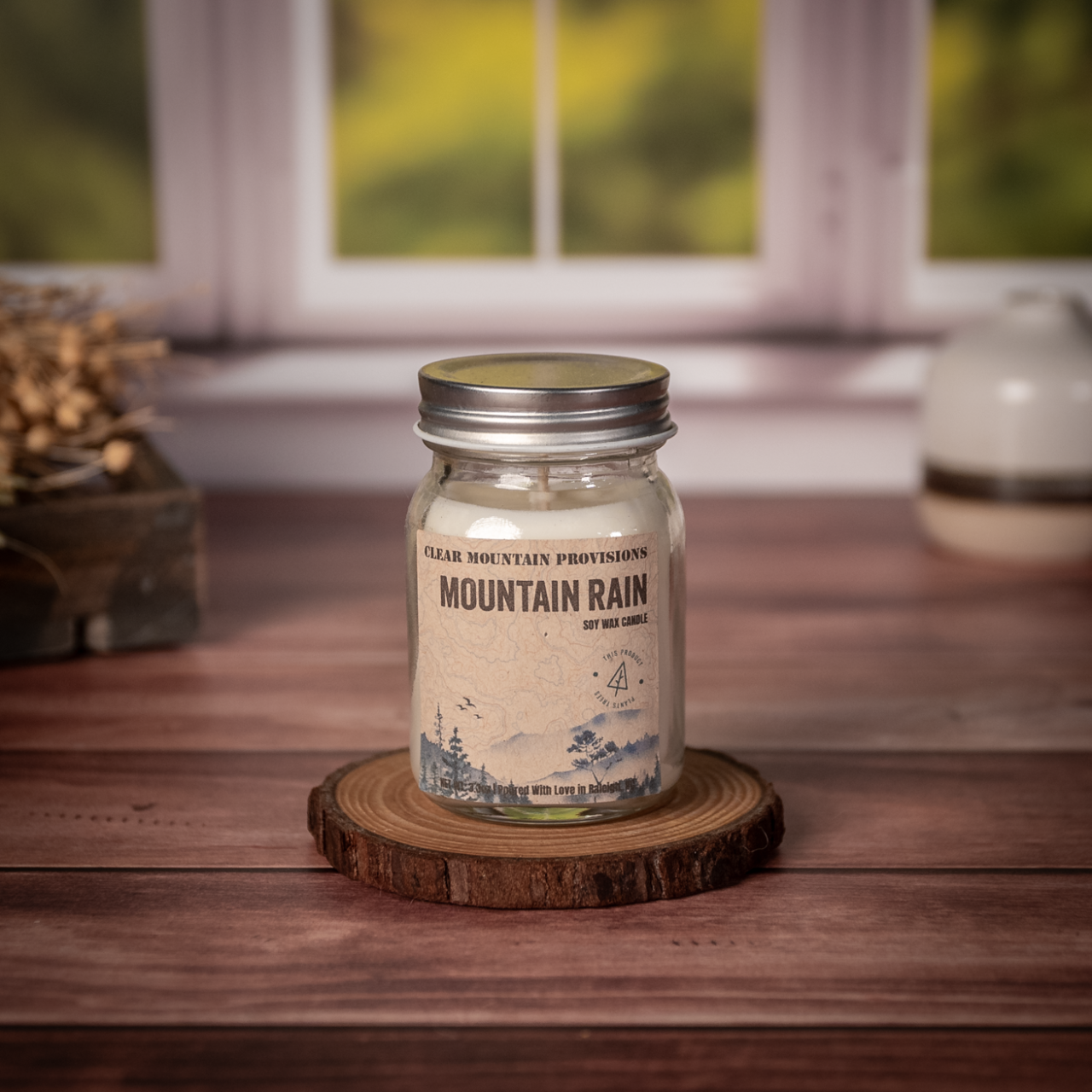 Mountain Rain soy wax candle with fresh rain, jasmine, and oakmoss scent in eco-friendly jar